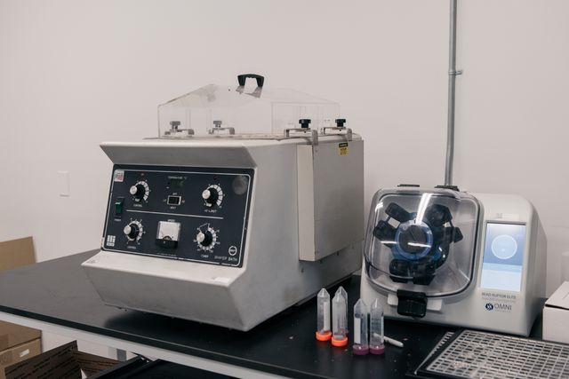 An orbital shaker (left) used to help with extraction and a Bead Ruptor (right) used to pulverize cannabis flower into dust so that it’s more homogenous for testing, May 3rd, 2022.